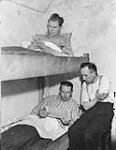 Patients in an underground Dutch hospital. )Above): Mr. W. Meulemberg. (Below, L-R): Messrs. Frank Tendam, R. Zuuring 2 Jan 1945