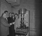 Msgr. O. Maurault and Dr. Armand Frappier receiving donation of money needed to purchase an electron microscope for the University of Montreal 1950