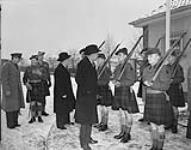 V.I.P.'s visit 27th Canadian Infantry Brigade. Finance Minister Douglas Abbott and Justice Minister Stuart Garson inspect a Guard formed from the Royal Highland Regiment of Canada 29 Jan. 1952