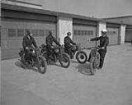 Canadian Officers Training Corps at Royal Canadian School of Signals. Officer cadet G.W. Procter and some of his comrades take motorcycle instruction 23 June 1950
