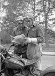 Despatch riders Doug Reid and Norman Given of the 9th Canadian Infantry Brigade checking the route of a convoy taking part in a training exercise, England, 17 May 1944 May 17, 1944.