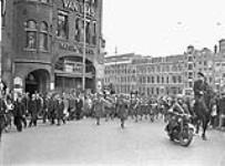 The Canadian Women's Army Corps (C.W.A.C.) Brass Band en route from the Royal Palace to the City Theatre, Amsterdam, Netherlands, 25 July 1945 July 25, 1945.