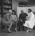 Governor-General Georges Vanier speaks with Dr. Elizabeth Cass of the Inuvik General Hospital, while Mme Vanier speaks to Maisie Camsell, a grand-niece of Doctor Charles Camsell June 1961
