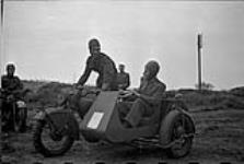 Trainees riding a sidecar motorcycle during a despatch riders' training course 1 May 1942