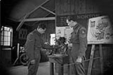 Despatch rider trainee learning about the operation of the Norton motorcycle engine 1 May 1942
