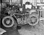 25th Canadian Infantry Brigade training - Cecil Magee carrying out repairs on a British Norton Motorcycle 31 Jan. 1951