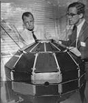 Scientists of the Defence Research Board with a prototype model of the Topside Sounder satellite. (L-R): Keith Brown, Dr. C.A. Franklin ca. 20 Mar. 1962