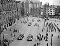 2 Canadian Infantry Division parade in front of Queen Wilhelmina. Scout cars of Manitoba Dragoons pass the base 28 June 1945