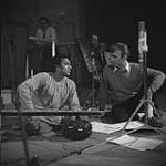 Norman McLaren, film creator with the National Film Board, and sitar player Ravi Shankar, discussing music during recording for the film A Chairy Tale Mar. 1957