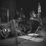 Norman McLaren, film creator at the National Film Board, and Ravi Shanker, sitar player, discussing the music to accompany A Chairy Tale Mar. 1957