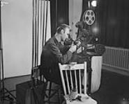 Norman McLaren, film creator at the National Film Board, working on a film in a studio Jan. 1951