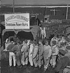 Personnel of The New Brunswick Rangers lining up to buy refreshments from a mobile canteen operated by the Knights of Columbus May 1943