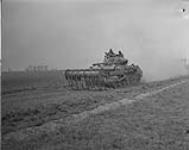 Sherman tank equiped with Flails on the move for Canadian attack 6 Aug. 1944