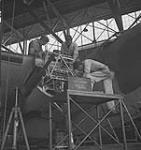 Personnel servicing Lockheed 'Hudson' aircraft of R.A.F. Ferry Command en route to Britain May 1943
