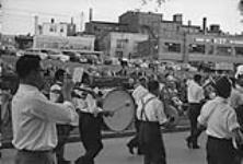 A brass band marching down a Stratford street during the first Stratford Shakespearean Festival 1953.