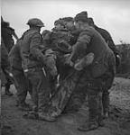 German prisoners carrying a wounded man 8 Feb. 1945