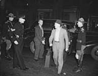 Royal Canadian Mounted Police (R.C.M.P.) escorting prisoner 10 Sept. 1939