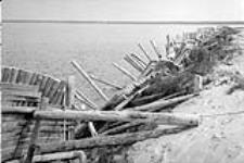 Apparently a wooden barrier restraining erosion along riverbank 1973