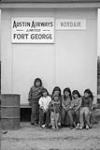 Group of Cree children below Austin Airways and Nordair signs 1973