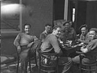 Infantrymen of the 1st Canadian Infantry Division resting after liberating Apeldoorn, Netherlands, 17 April 1945 April 17, 1945.