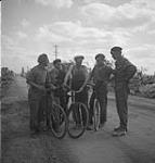 Belgian and Canadian officers talking with French civilians 17 Aug. 1944