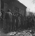 German prisoners being searched at Company headquarters of the 1 Canadian Parachute Battalion 24 Mar. 1945