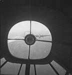 View showing Handley Page 'Halifax' towplane, taken through nose of a General Aircraft 'Hamilcar' glider of the 6th Airborne Division carrying personnel of the 1st Canadian Parachute Battalion to Germany 24 Mar. 1945