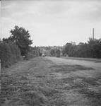 Canadian soldiers marching in the road after attack 16 - 17 Aug. 1944