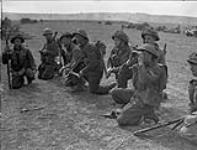 Lieutenant J. McKinnell (third from right) briefing infantrymen of The Stormont, Dundas and Glengarry Highlanders during a training exercise, England, 14 April 1944 April 14, 1944.