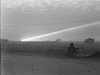 Night photograph of anti-aircraft searchlight in the distance 29-Jul-44