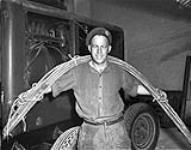 Sapper Fred Hudson with electrical cables connecting generator to the press used to print the first issue of THE MAPLE LEAF 28-Jul-44