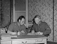 Personnel addressing mailing wrappers in the circulation room of THE MAPLE LEAF. (L-R): Private Robert Sawyer, Corporal Arnold Hall 28-Jul-44