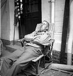 Photographer Eddie Worth of the Associated Press taking a rest in Caen, France, 28 July 1944 July 28, 1944.