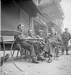 The new N.A.A.F.I. canteen 'The Pop Inn'. L. to r.: Pte. Charlie Ross, Lt. Michael (Mickey) Dean and Lt. George A. Cooper 27-Jul-44