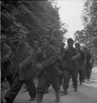 The Stormont, Dundas & Glengarry Highlanders with prisoners, inlcuding two Mongolians from Russia 18-Jul-44