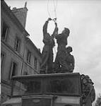Personnel of the Royal Canadian Engineers clearing away damaged electrical wires 11-Jul-44