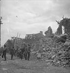 Personnel of the Royal Canadian Engineers clearing rubble from a street in Carpiquet 12-Jul-44