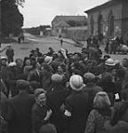 French civilians receiving Allied information pamphlets regarding liberation 10-Jul-44