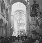Interior of Abbey Auxhommes where French civilians have been living during bombing 11-Jul-44
