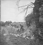 Photographer Eddie Wartel moving into position during action 09-Jul-44