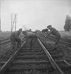Men from 332 Pioneer Company, British Army, tightening loose bolts on the Cherbourg-Paris Railway line 08-Jul-44
