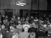 "Education in occupied Germany: At a meeting of the school teachers of the district of Leer, held in the Ratskeller (town hall) there, they learn from their directors the aims and intentions of thenew educational scheme which is being adopted" 30 Aug. 1945