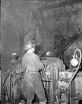 Employee of Gaspé Copper Company operating a drill Aug. 1957