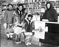 [William Joss issuing Family Allowances to Inuit in new Hudson's Bay Co. store] Original title: William Joss issuing Family Allowances to natives in new Hudson's Bay Co. store 1950