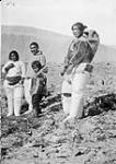 Inuit from Etah (Greenland) brought over to work for Royal Canadian Mounted Police (R.C.M.P.) at Dundas Harbour. From left to right: Sumingy, Panikpa and their kid 31 July 1928.