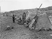 Inuit in front of tupiks at Eywack Station, Pond Inlet, N.W.T., [(Mittimatalik/Tununiq), Nunavut], October 1906 October 1906.
