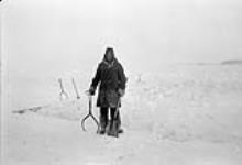 Inuit near cut ice used for fresh water 1956-1957