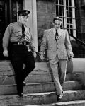 Wilbert Coffin leaving Court House handcuffed to guard (from a copy negative) ca. July 1954