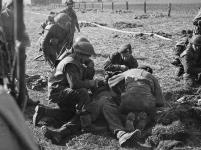 Regimental Aid Party treating a infantryman of The South Saskatchewan Regiment who was wounded by sniper fire while crossing a canal north of Laren, Netherlands, 7 April 1945 7 avril 1945