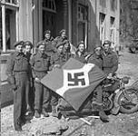 Personnel of The Lake Superior Regiment (Motor) with a captured German flag, Friesoythe, Germany, 16 April 1945 April 16, 1945.